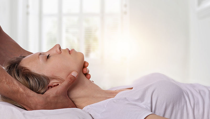 Woman getting neck adjusted by chiropractor